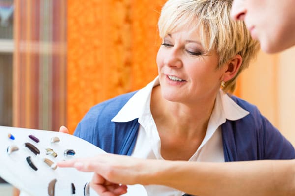 Woman chooses a hearing aid