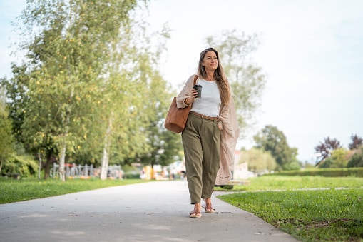 Relaxed woman taking a walk on a peaceful sunny day