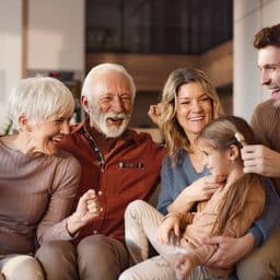heerful multi-generation family having fun during their time in the living room.